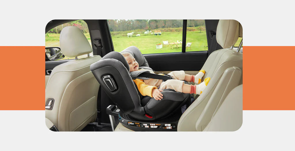 Child in a car seat inside a vehicle with a scenic background